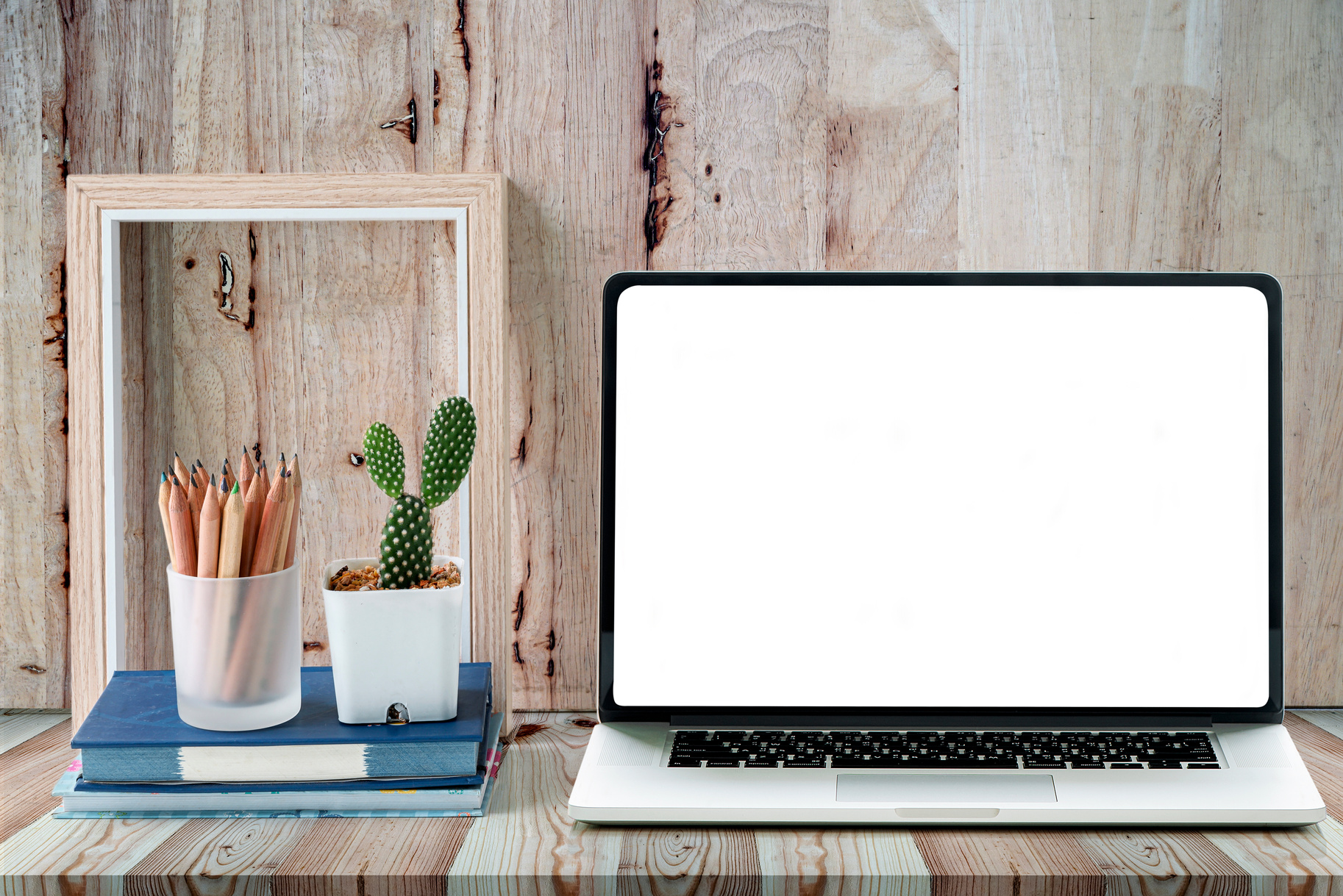 White Blank Screen Laptop and Wooden Picture Frame